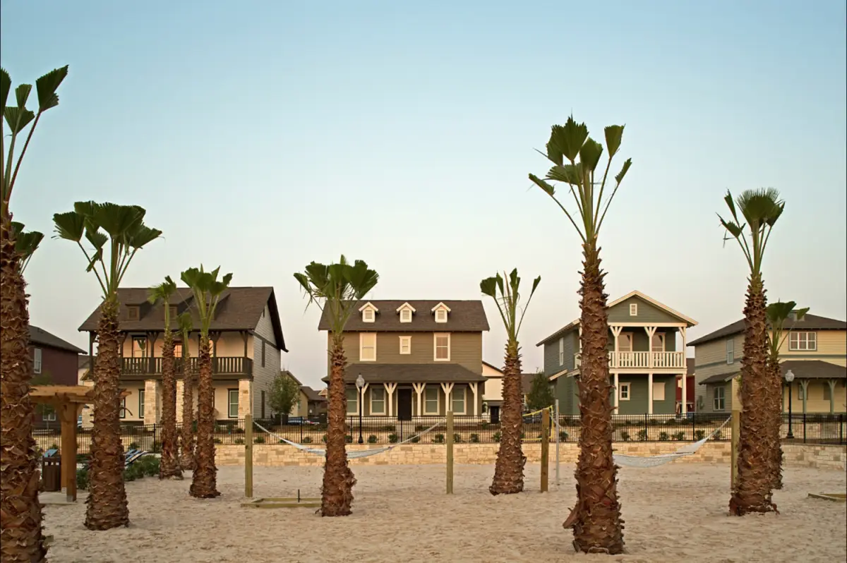 palm trees behind volleyball the cottages of college station